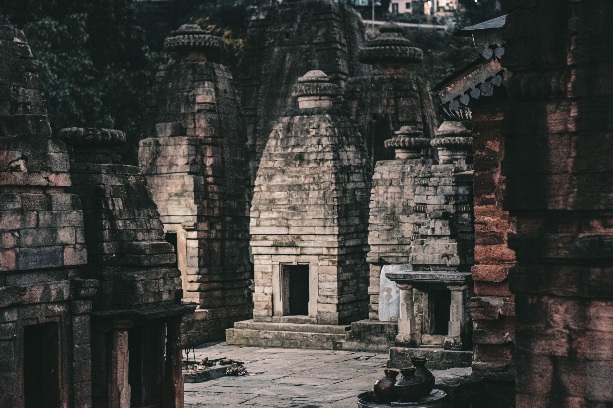 Home Ancient stone temples with intricate architecture in a moody, mystical setting.